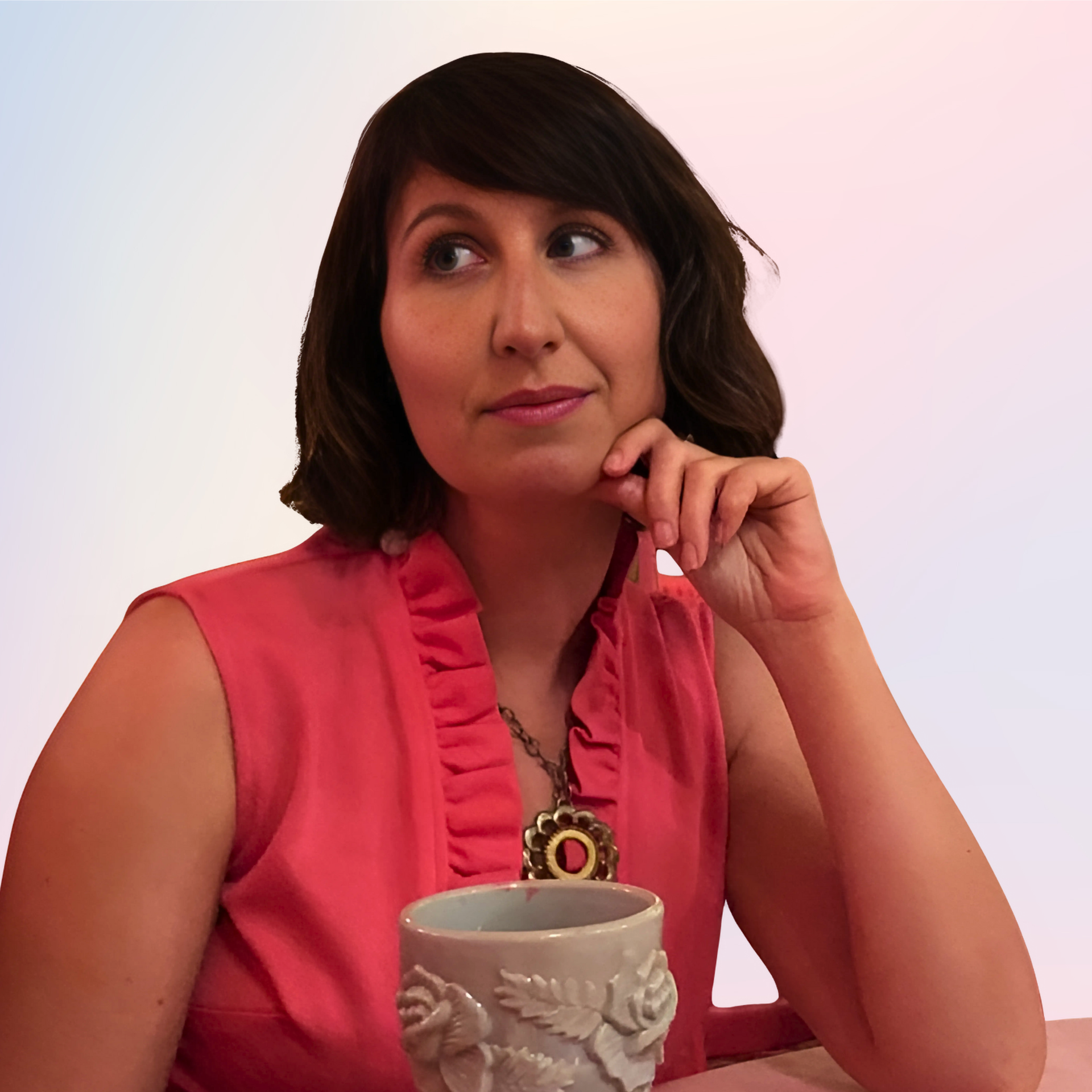 a woman leaving on a table with a goblet in a ruffled top and one hand on her chin looking off to the side.